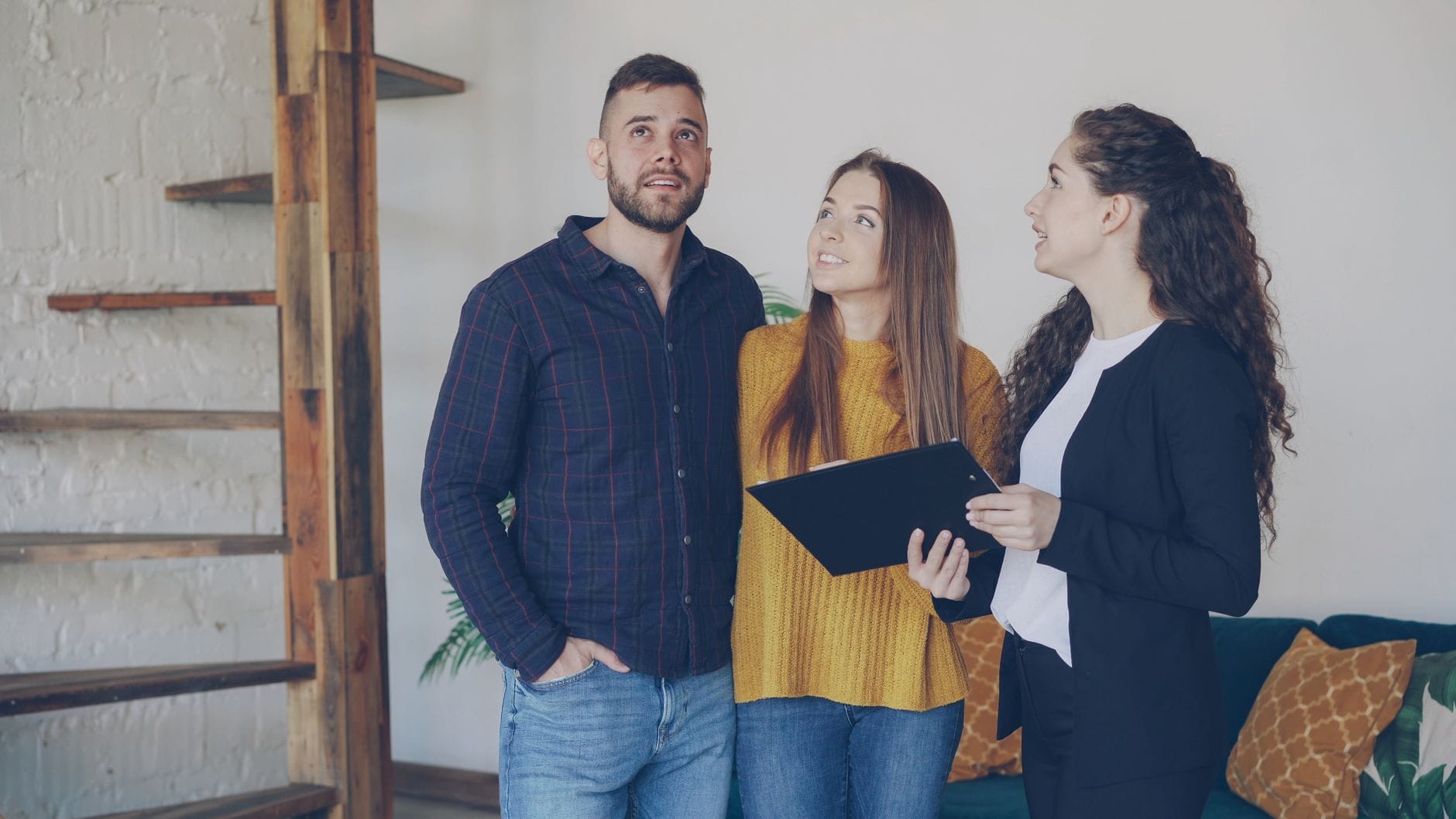 Real estate agent meeting with a couple during a home buyer consultation