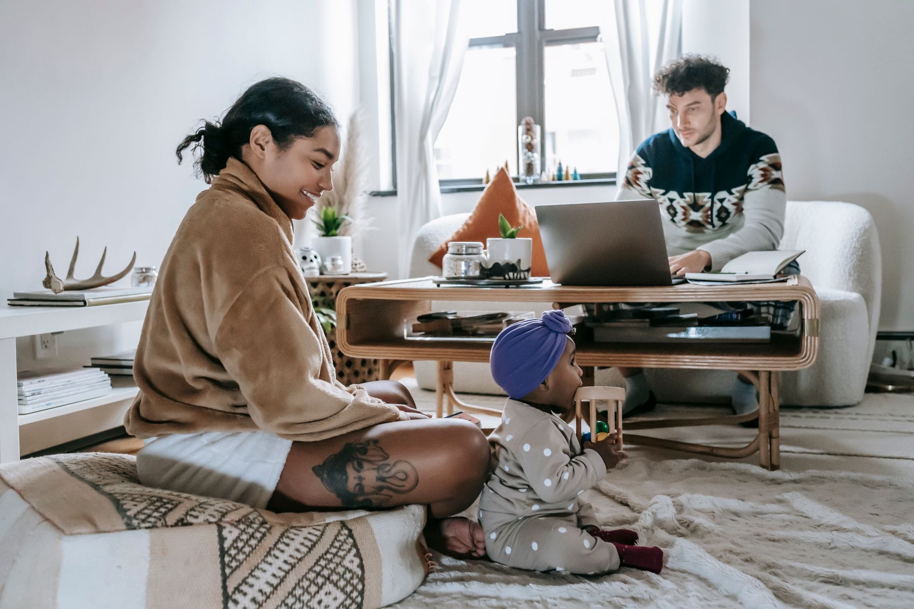 Parent working from home with a child in a modern living room