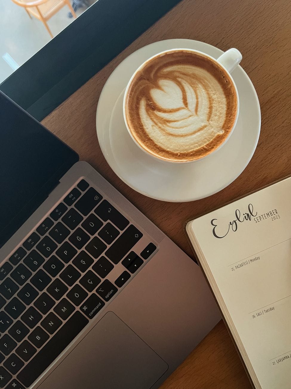 Laptop, coffee and notepad representing flexible part-time work