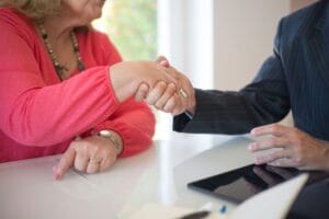 Professional handshake over a desk during a real estate meeting