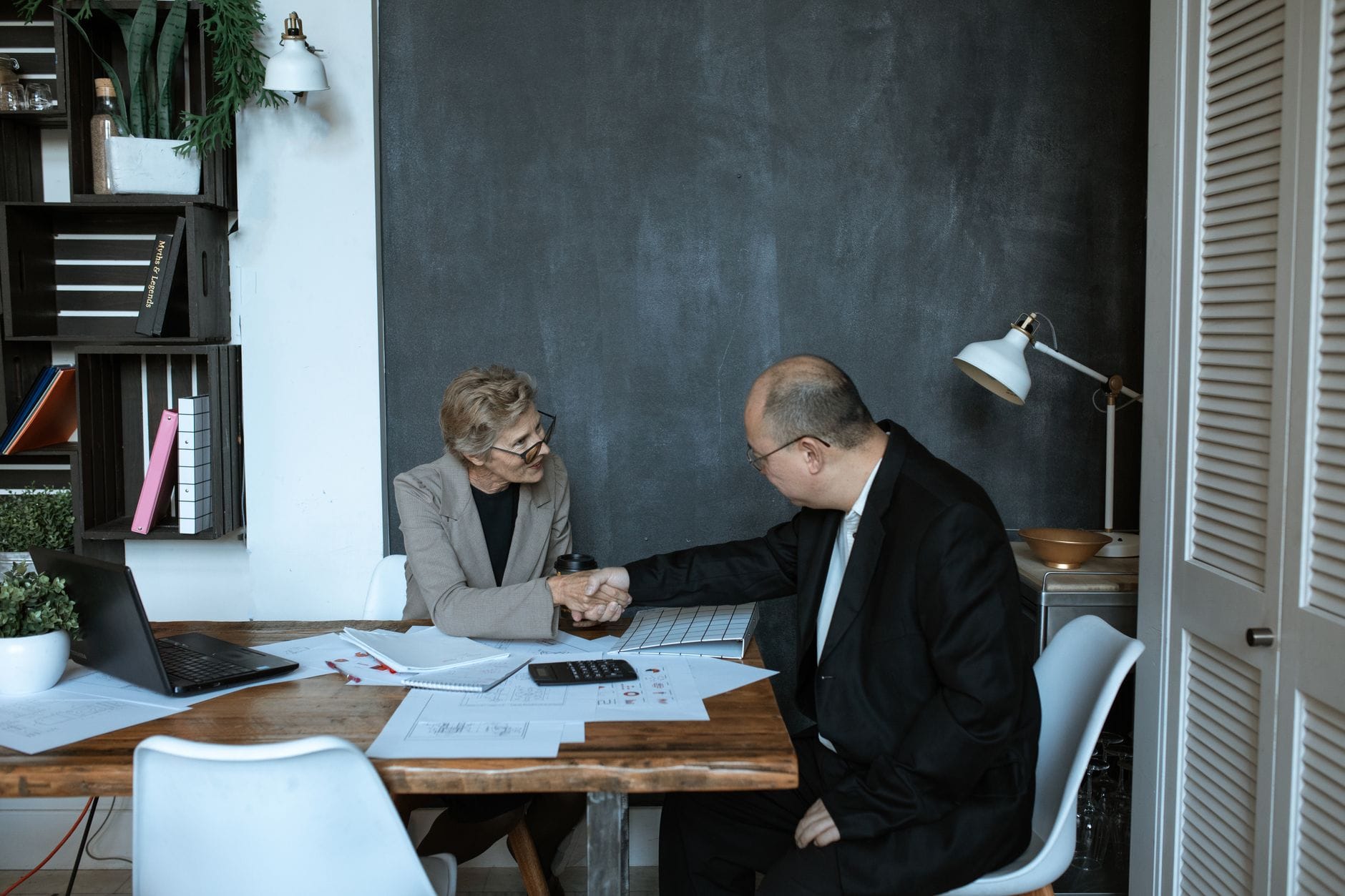 Two professionals meeting at a modern office desk
