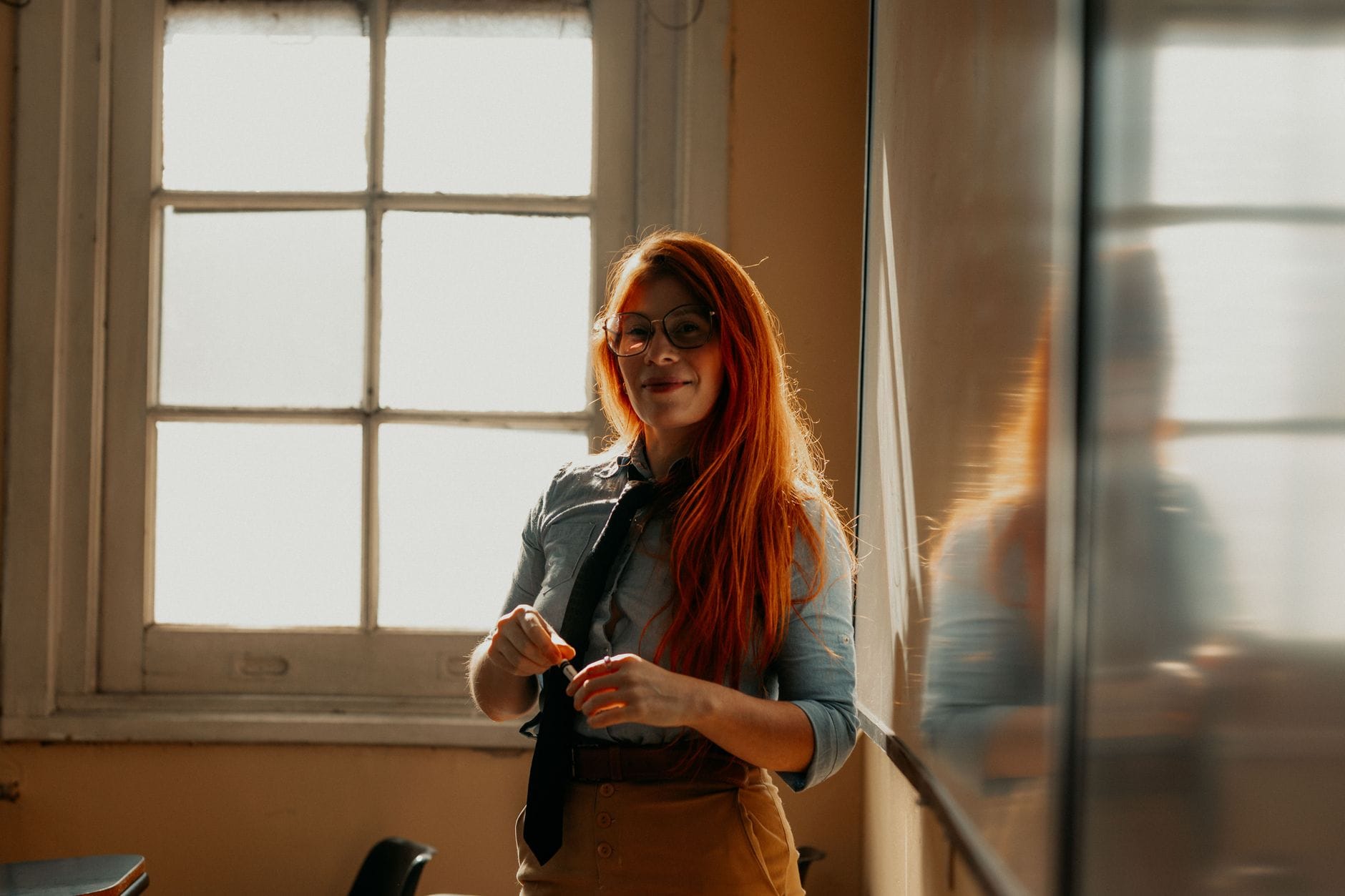 Teacher in a bright classroom setting considering a career change